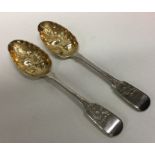 A pair of heavy fiddle pattern silver berry spoons