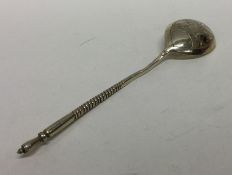 A Russian silver gilt spoon with engraved decorati