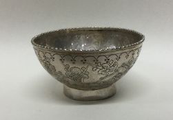 A Chinese chinoiserie silver bowl with beaded rim.
