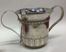 A George III two handled silver porringer with flu