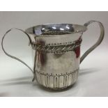 A George III two handled silver porringer with flu