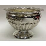 A chased silver half fluted rose bowl with gilt in