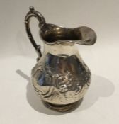 An attractive Victorian silver embossed cream jug