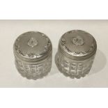 A pair of Edwardian silver dressing table jars wit
