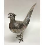 A heavy cast silver figure of a cock pheasant in sta