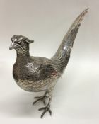 A heavy cast silver figure of a cock pheasant in sta