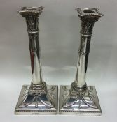 A pair of large silver candlesticks with beaded ri