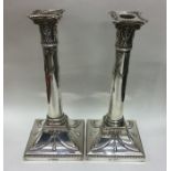 A pair of large silver candlesticks with beaded ri