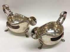 A pair of heavy Georgian silver sauce boats with c