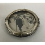 A circular silver picture frame in the form of a l