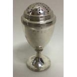 A Georgian silver caster with reeded decoration. L