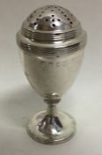 A Georgian silver caster with reeded decoration. L