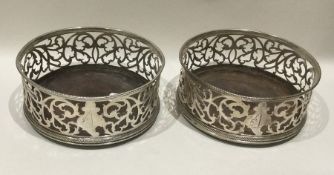 A good pair of Georgian silver pierced wine coaste