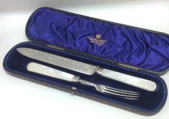 A cased silver and MOP bread knife and fork. Sheff