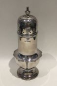 An Edwardian silver sugar caster of shaped form. B