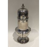 An Edwardian silver sugar caster of shaped form. B