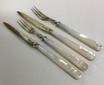 A pair of tapering silver and MOP dessert forks an