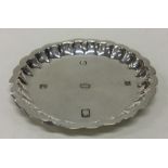 An Edwardian silver pin dish with shaped border. L