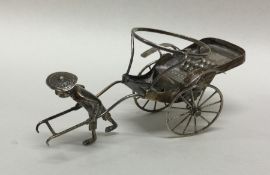 A Chinese silver model of a man and cart. Punched