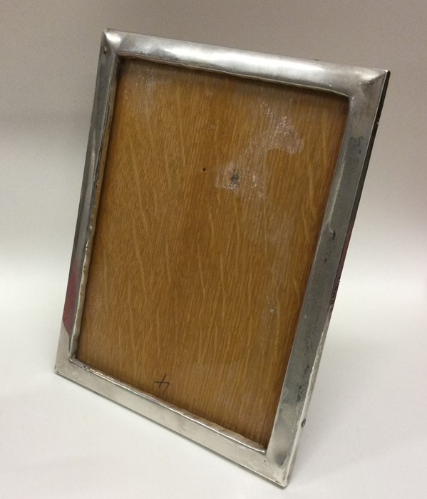 A plain silver picture frame of rectangular form.