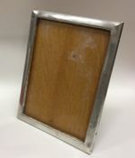 A plain silver picture frame of rectangular form.
