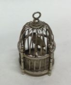 A Dutch figure of a bird in cage with pierced deco