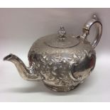 A good quality embossed silver teapot decorated wi