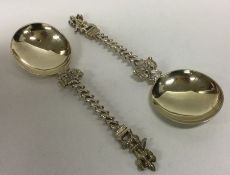A heavy pair of cast silver spoons of Indian desig