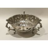 An embossed silver sweet dish decorated with flowe