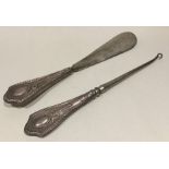 A pair of silver mounted button hooks / shoe horns