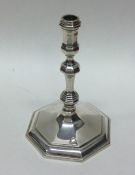 A heavy octagonal cast silver taper stick. London