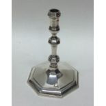 A heavy octagonal cast silver taper stick. London