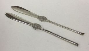 A pair of heavy silver cast lobster picks with eng