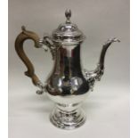 A large Georgian silver tapering coffee pot with t