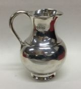 A novelty silver cream jug in the form of a milk c