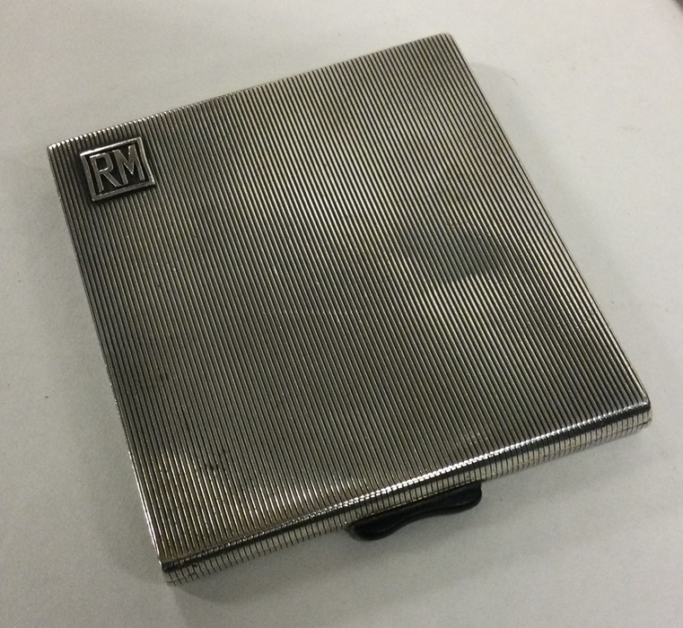 A heavy Art Deco silver cigarette case with reeded