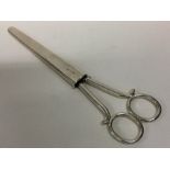 A good pair of large silver scissors contained wit