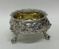 A heavy cast silver salt embossed with scrolls and