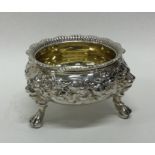 A heavy cast silver salt embossed with scrolls and