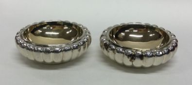 A heavy pair of silver and silver gilt fluted salt