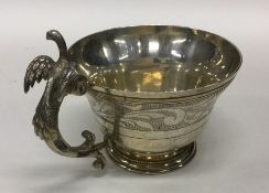 A fine quality silver gilt tapering cup with bird