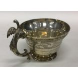 A fine quality silver gilt tapering cup with bird