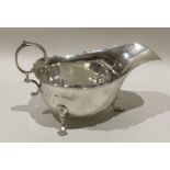 An Edwardian silver sauce boat with card cut rim.