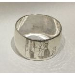 A heavy Edwardian silver napkin ring decorated wit