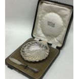 A cased silver butter shell together with matching