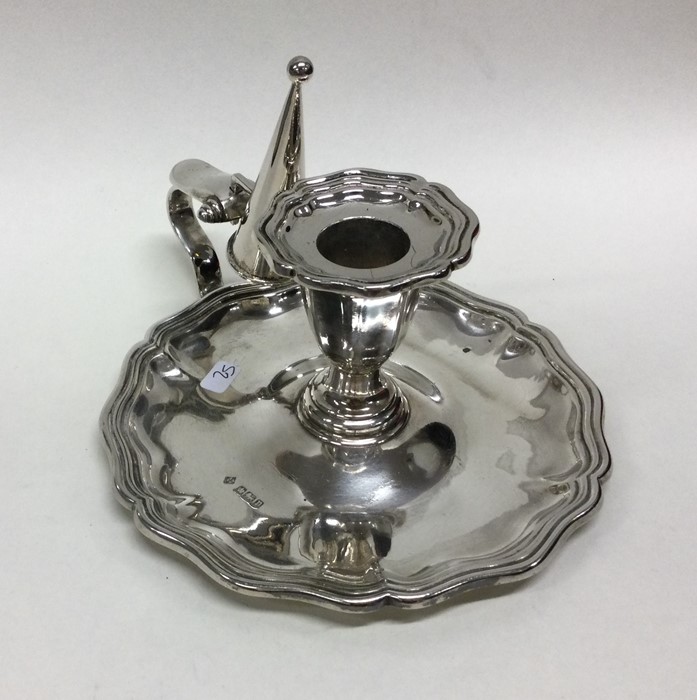 An Edwardian silver chamber stick together with ma