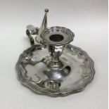 An Edwardian silver chamber stick together with ma