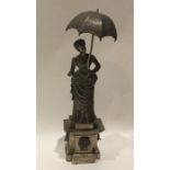 A heavy cast silver figure of a Victorian lady wit