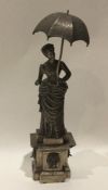 A heavy cast silver figure of a Victorian lady wit