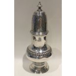 A heavy Edwardian silver baluster shaped caster. L